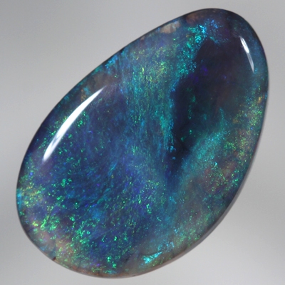 SOLID BLACK CRYSTAL OPAL Constant green and blue fire engulf a patch of black opal